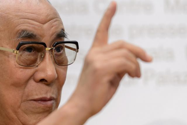 The Dalai Lama gestures during a press conference after visiting the Swiss House of Parliament on 16 April 2013 in Bern.