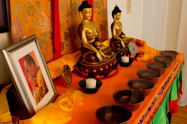 Tibetan Buddhist altar with the seven water offering bowls, and photo of His Holiness Dalai Lama.