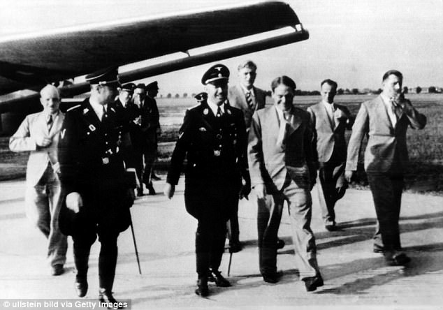 Heinrich Himmler (left, front) welcomes members of the SS Tibet expedition, which includes Ernst Schäfer (one from right in front row) on their return to Munich Riem Airport in Germany.