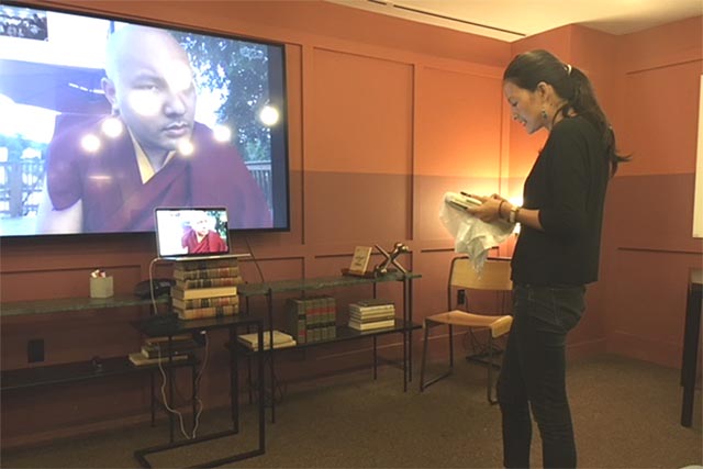 A Tibetan woman talking with the 17th Karmapa during an online group conference between the Karmapa and the DC Tibetan Book Club,  in Washington DC on 25 August 2018.