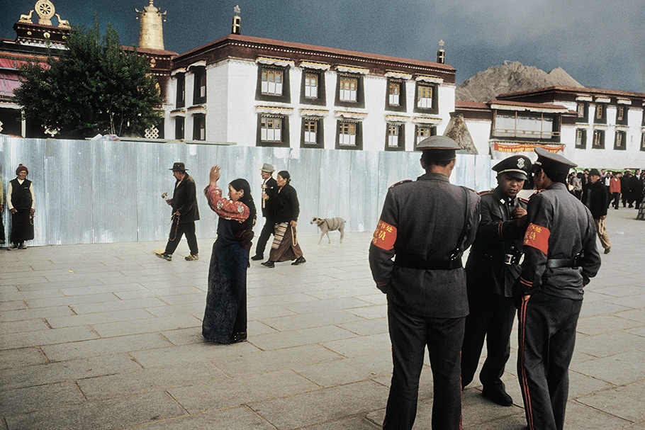 Pilgrims in the holy centre of Lhasa are under strict police surveillance. This square has been the site of numerous demonstrations against the Chinese occupation. Jokhand Square, Lhasa, May 2002.
