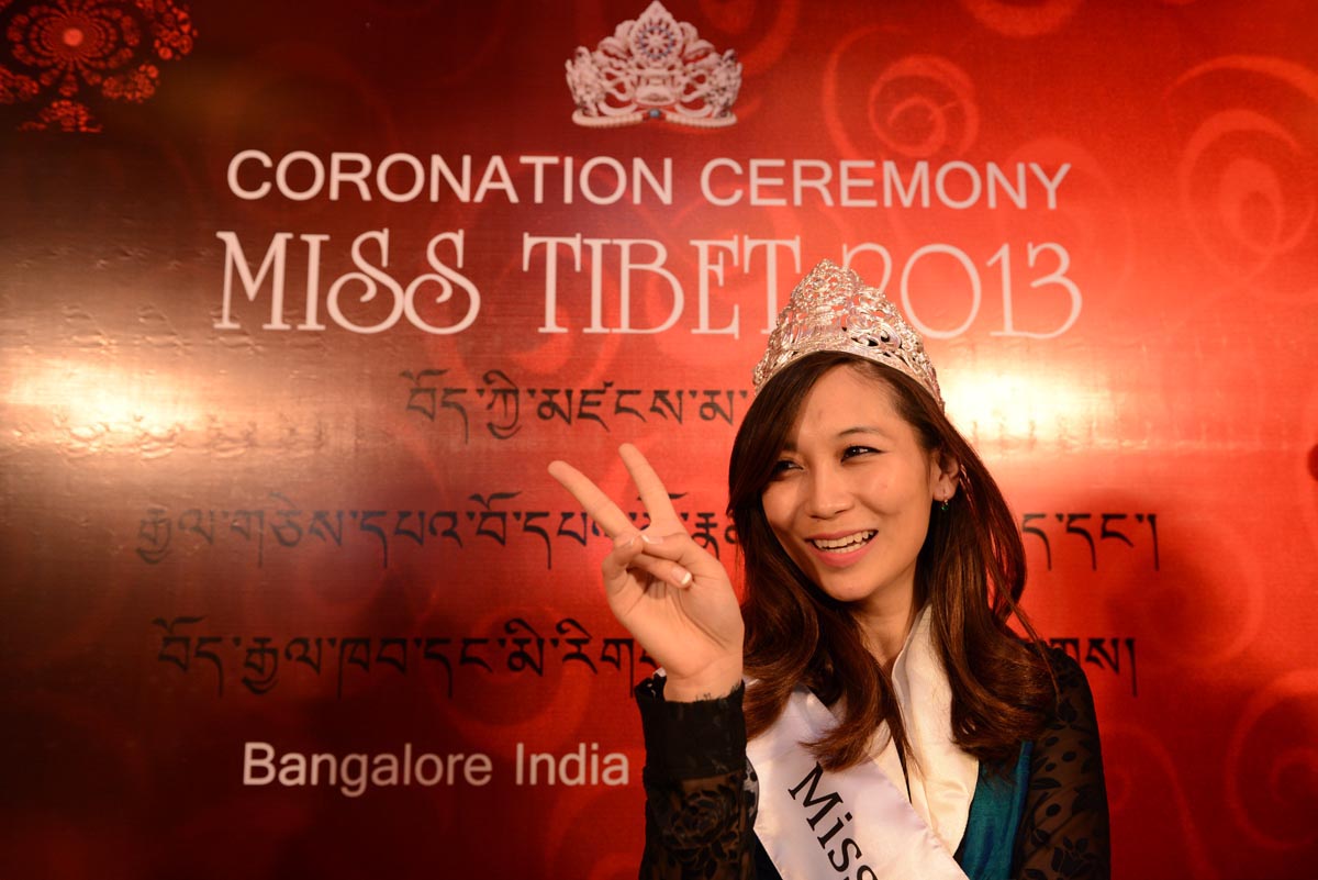 Miss Tibet 2013 Tenzing Lhamo poses for a photo after being crowned the new Miss Tibet, giving victory sign.