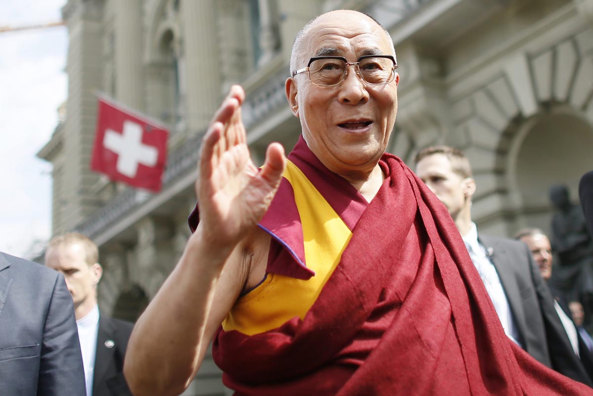 Dalai Lama waves outside the Swiss Parliament