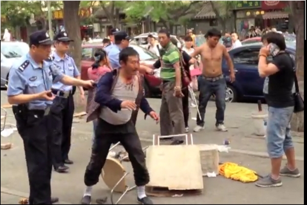 Chinese and Tibetans fighting on the street in Beijing.