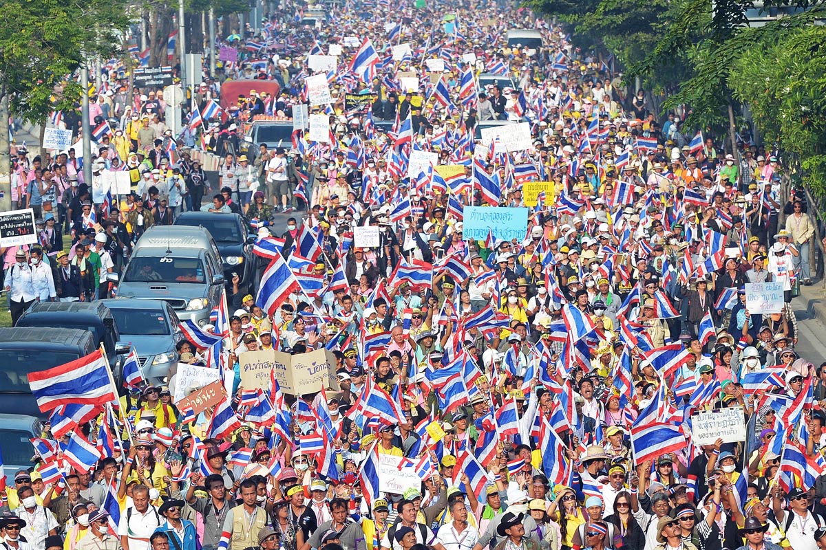 Thai anti-government protesters wave national flags in Bangkok