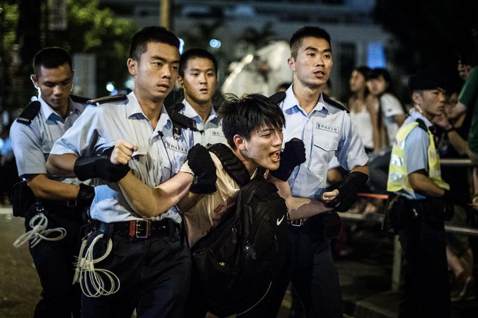 Policemen remove protesters in the central district after a pro-democracy rally in Hong Kong.