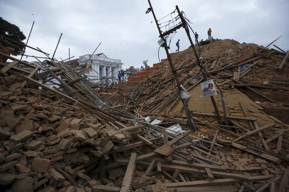 People work to rescue trapped people inside a temple in Bashantapur Durbar Square after an earthquake hit, in Kathmandu, Nepal.