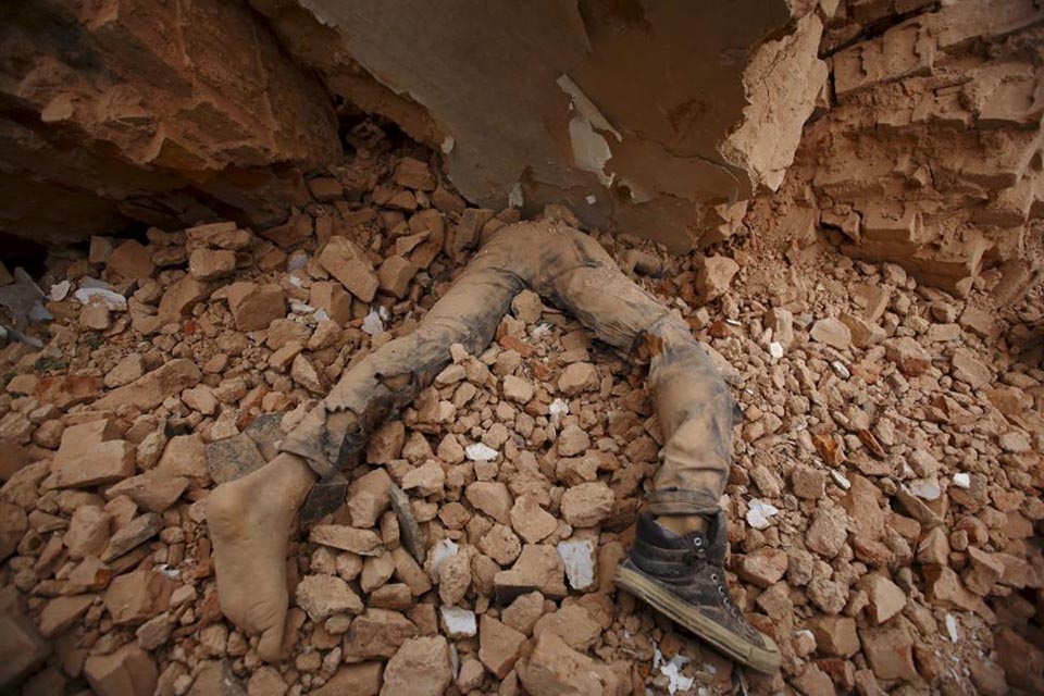 A body of a victim lies trapped in the debris after an earthquake hit in Kathmandu, Nepal, on 25 April 2015.