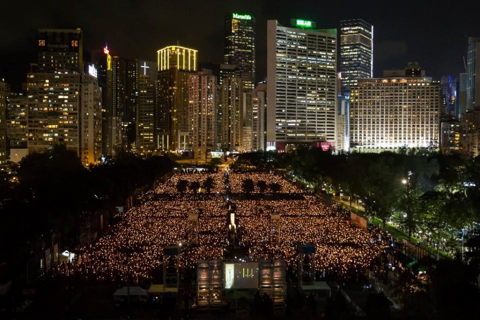 People take part in a candlelight vigil in Hong Kong on 4 June 2015, to mark the crackdown on the pro-democracy movement in Beijing's Tiananmen Square in 1989.