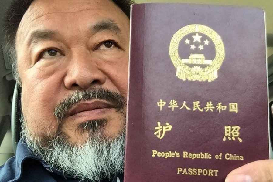 Chinese dissident artist Ai Weiwei holds his passport in Beijing on 22 July 2015.