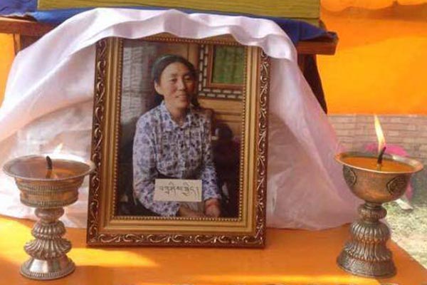Butter lamps are lit before a portrait of Tashi Kyi to pray for her after she set herself on fire to protest the repressive Chinese rule in Tibet, on 27 August 2015.
