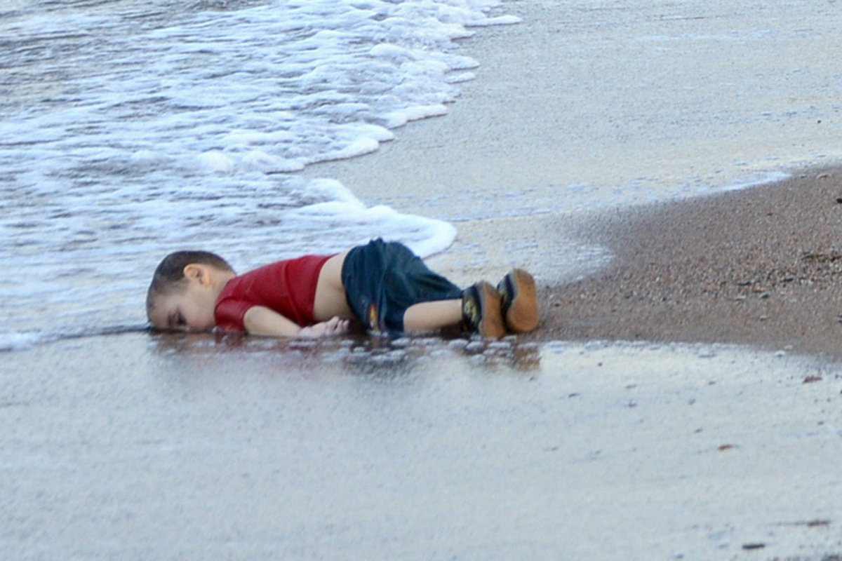 The lifeless body of Aylan Kurdi, 3,  who died after boats carrying Syrian refugees to the Greek island of Kos capsized, near the Turkish resort of Bodrum on 2 September 2015.