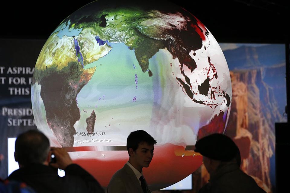 Visitors look at exhibits at the US stand at COP 21, the United Nations conference on climate change, at Le Bourget on 3 December 2015.
