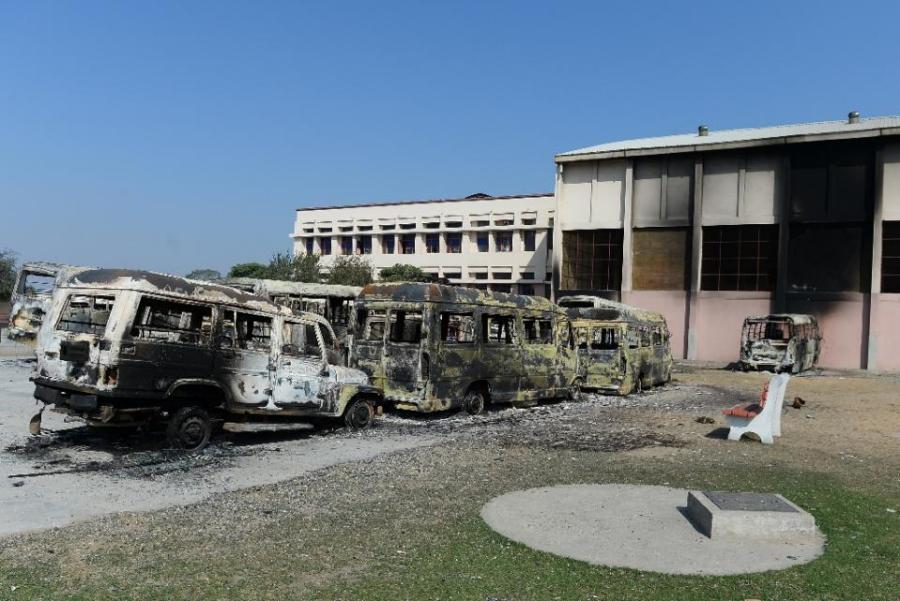 Burnt-out buses and fire damage to buildings are pictured at a school in the northern Indian city of Rohtak on 21 February 2016, following violent caste protests.