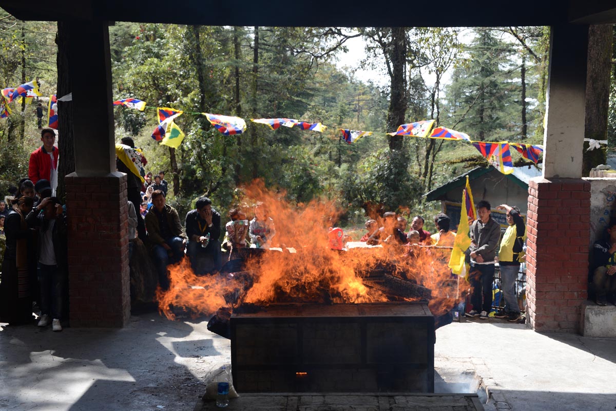 Grieving Tibetans look on as the body of Dorje Tsering is cremated in McLeod Ganj, India, on 6 March 2016.