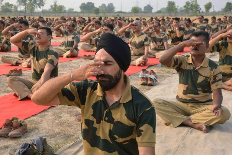 Indian Border Security Force personnel take part in a yoga session on International Yoga Day at BSF headquarters in Khasa on the outskirts of Amritsar on 21 June 2016.