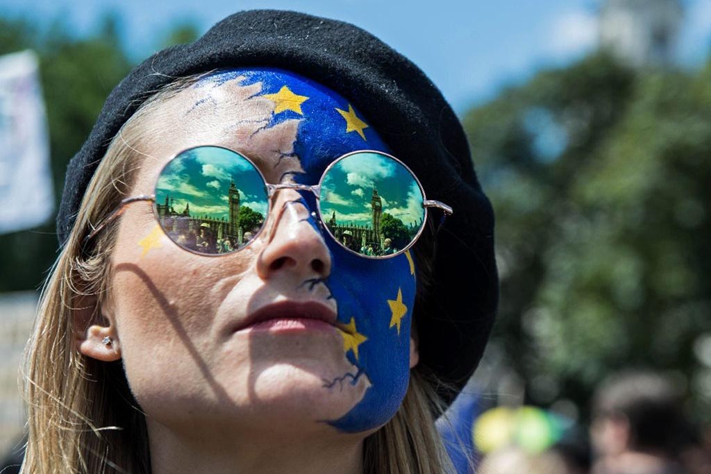 The Houses of Parliament are reflected in a woman's glasses as thousands of protesters joined a 'March for Europe' on 2 July 2016, to protest against Britain's vote to leave the European Union.
