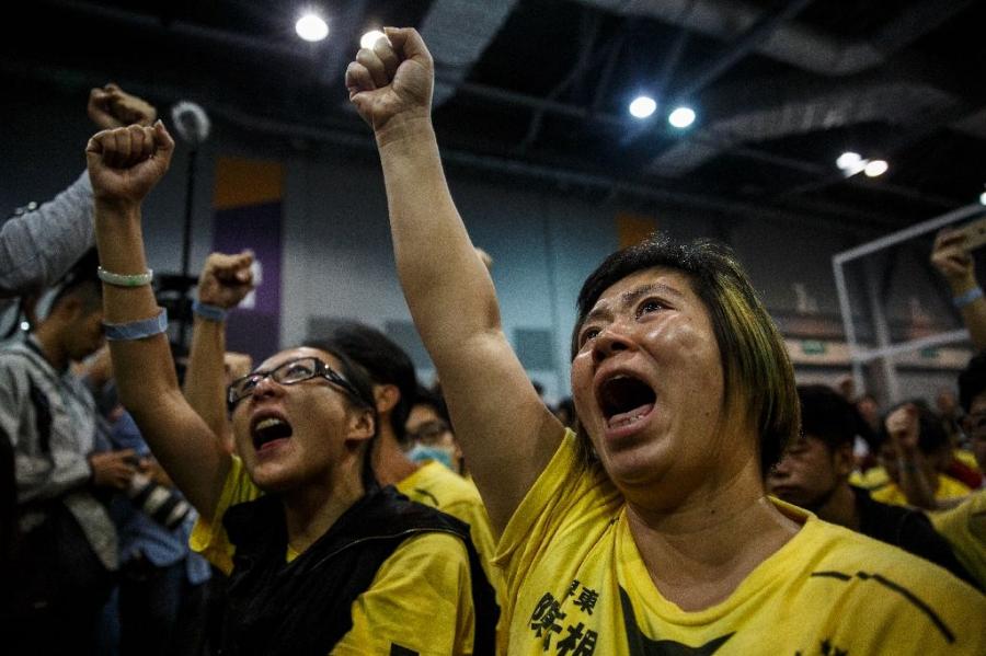 Supporters celebrate the win of Civic Passion's Cheng Chung-tai in the Legislative Council election, at the central counting station in Hong Kong, on 5 September 2016.