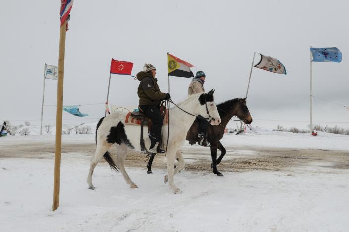 People ride horses in the Oceti Sakowin camp during a protest against plans to pass the Dakota Access pipeline near the Standing Rock Indian Reservation, near Cannon Ball, North Dakota, US, on 30 November  2016. 