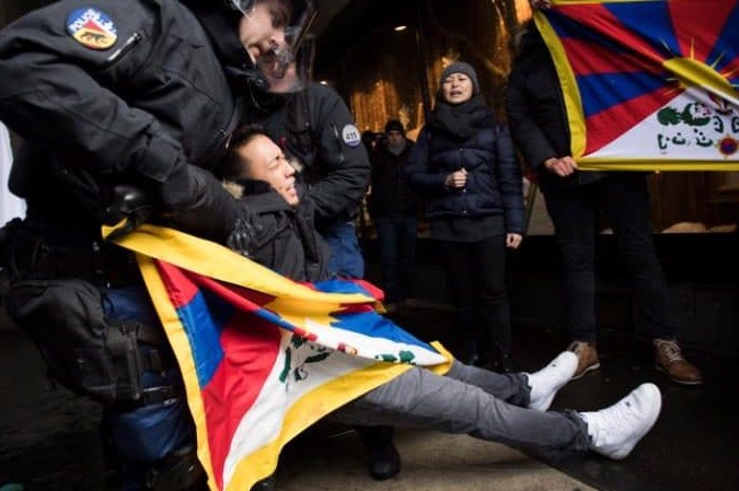 Police arrest a Free Tibet protester during a demonstration in Bern on 15 January 2017.