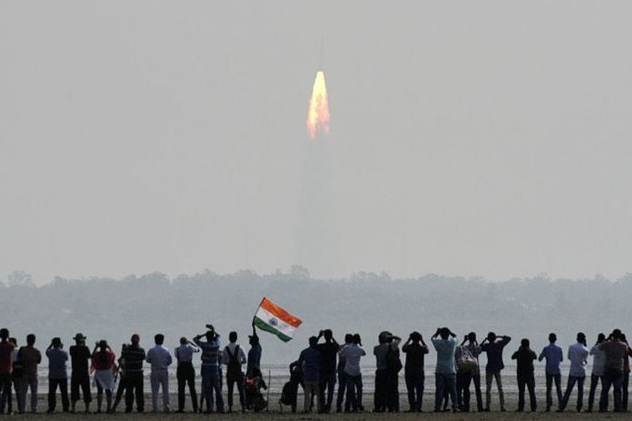 Onlookers watch the launch of the Indian Space Research Organisation (ISRO) Polar Satellite Launch Vehicle (PSLV-C37) at Sriharikota on 15 February 2017.