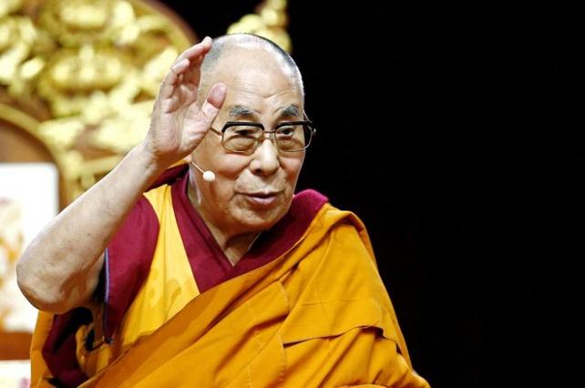 Tibet's exiled spiritual leader the Dalai Lama gestures during a teaching event in Milan, Italy on 21 October 2016.