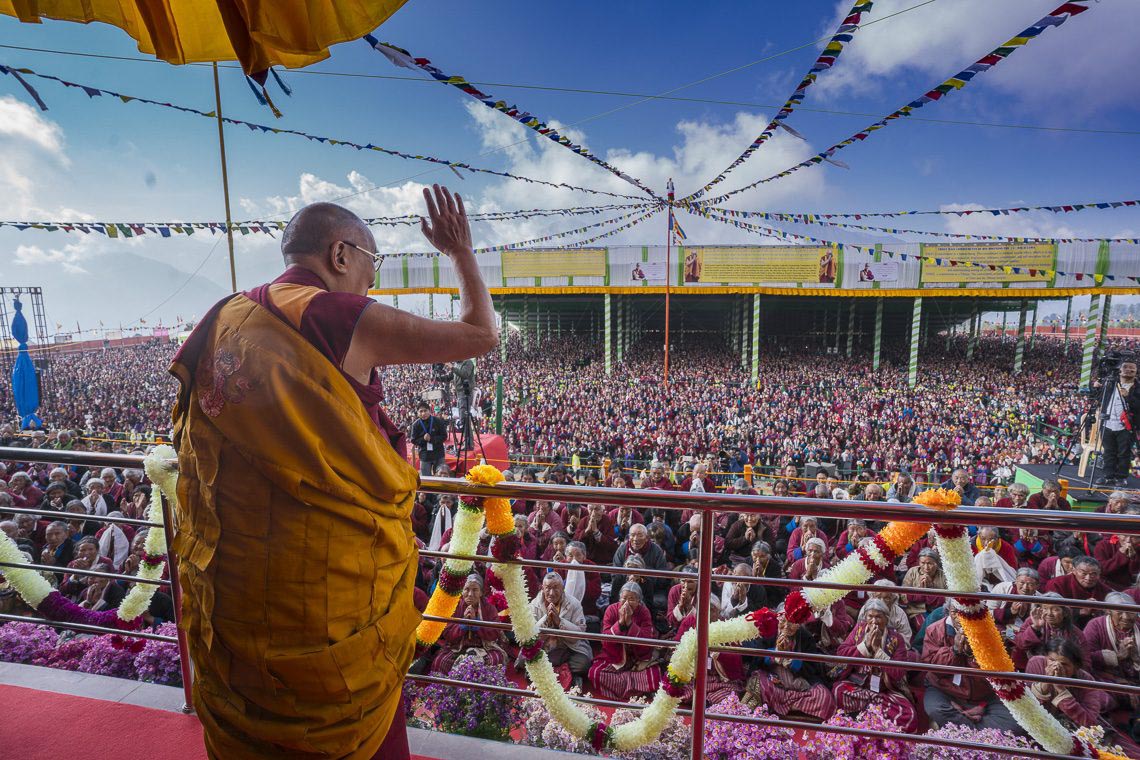 Tibetan spiritual leader Dalai Lama waves to followers as he arrives for the second day of teachings at Yiga Choezin grounds in Tawang, India, on 9 April 2017.