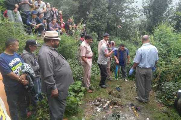 Police officials gathering evidence after charred remains of a Tibetan youth were found in a forest at McLeod Ganj on Saturday.