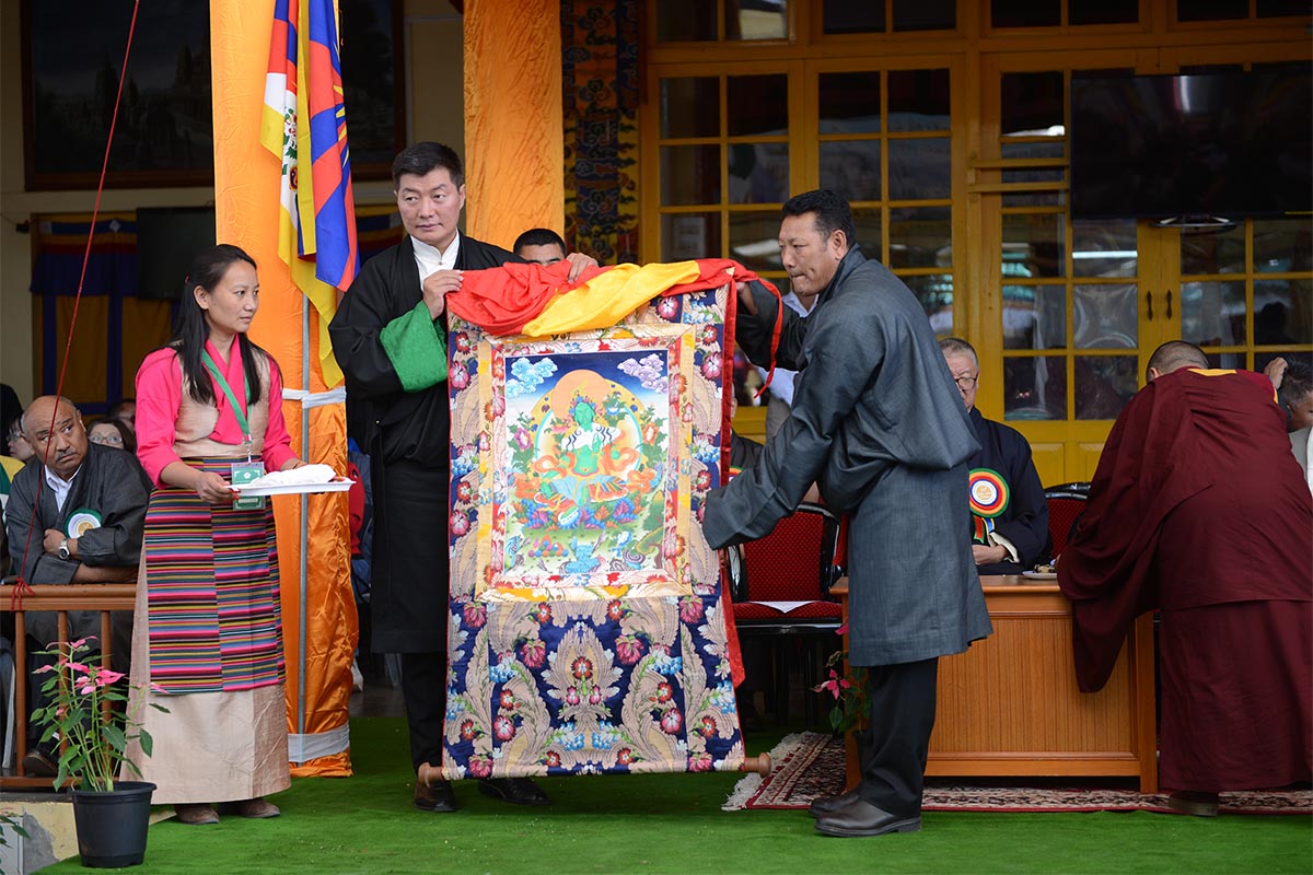 Tibetan Settlement Officer Dawa Rinchen presents a thangka as a memento celebrating the golden jubilee of the Tibetan Settlement Office Dharamshala to President of the Central Tibetan Administration Lobsang Sangay at Tsuglakhang temple in McLeod Ganj, India, on 9 October 2017.