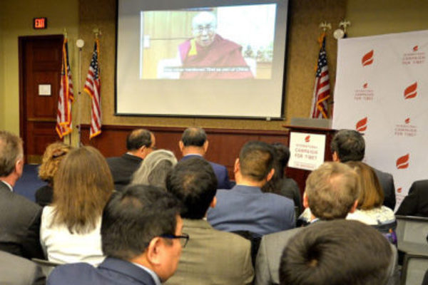 Chairman of International Campaign for Tibet Richard Gere, members of the US Congress, and guests watch a message by the Dalai Lama on the organisation's 30th anniversary event in Washington, DC, on 15 March 2018.