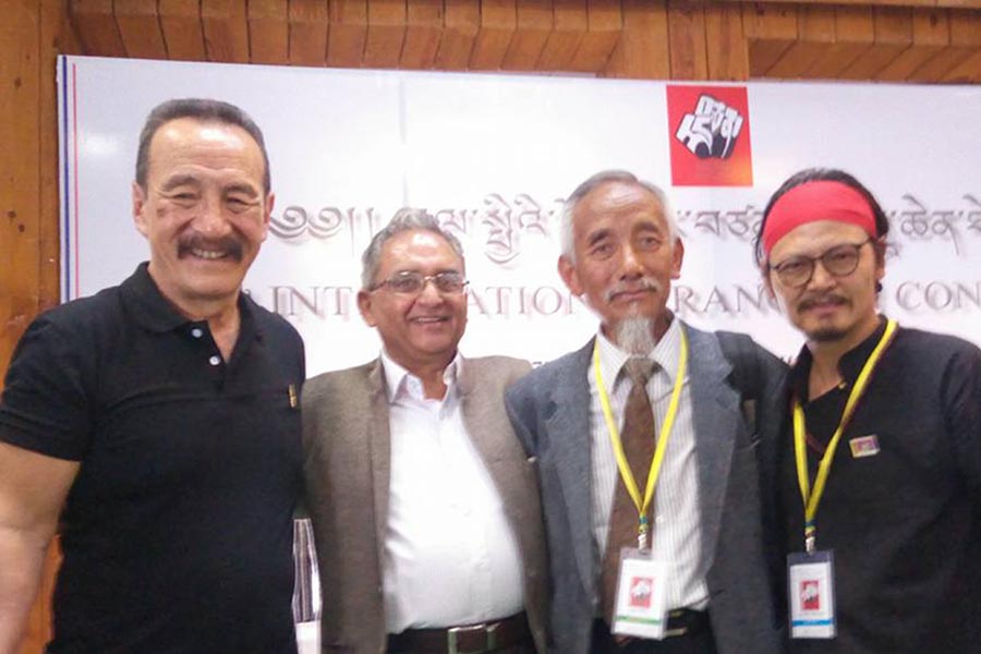 Prominent Tibetan independence advocates Jamyang Norbu (left), Lhasang Tsering (second right), Tenzin Tsundue (right), and supporter Vujay Kranti, during the opening of the Fifth International Rangzen Conference in Dharamshala, India, on 23 May 2018.