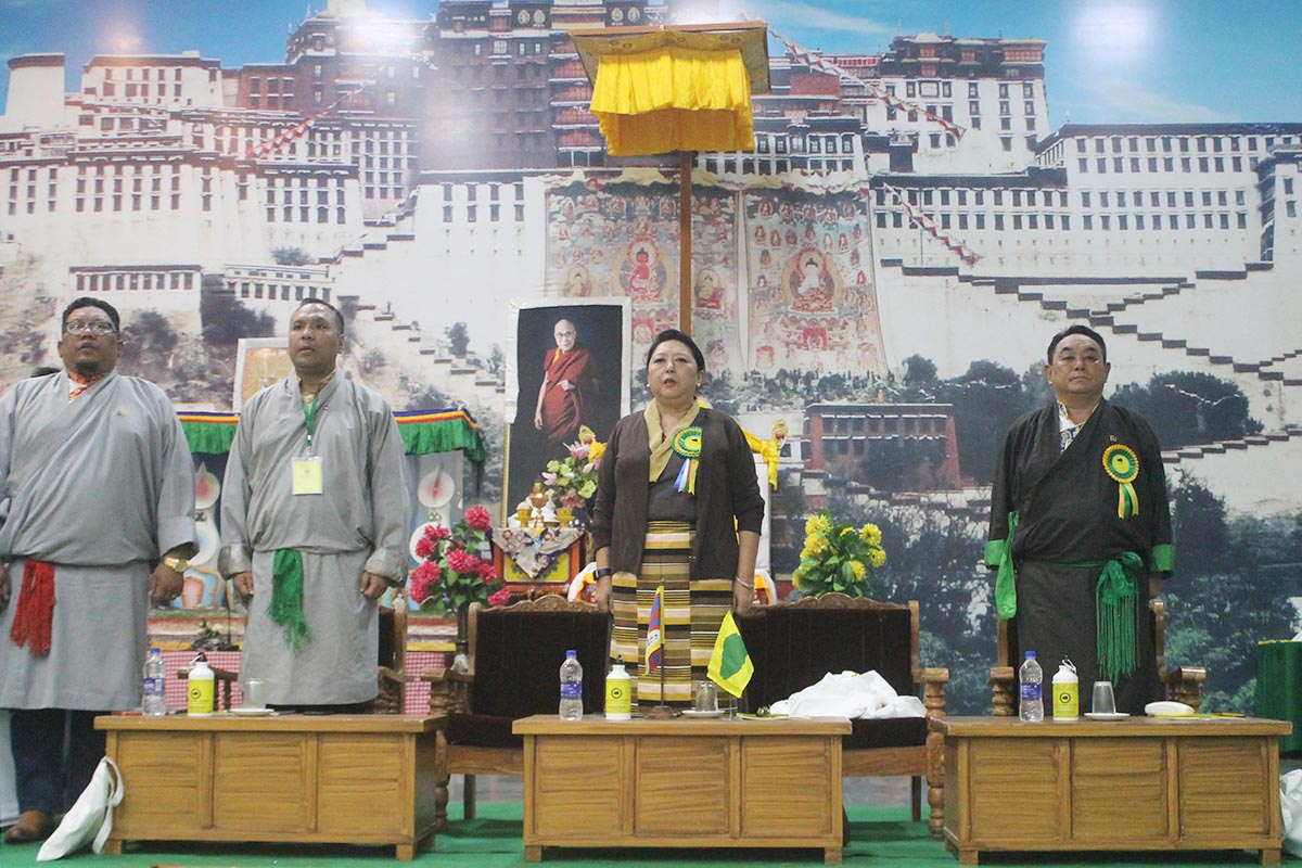 Delegates singing the Tibetan national anthem during the opening of the 49th Working Committee of the Tibetan Youth Congress at Dekyiling Tibetan Settlement, India, on 6 August 2018. From left: TYC Vice President Tamding Hrichoe, President Tenzing Jigme, former CTA Minister Gyari Dolma, and Dekyiling Settlement Officer Norbu.