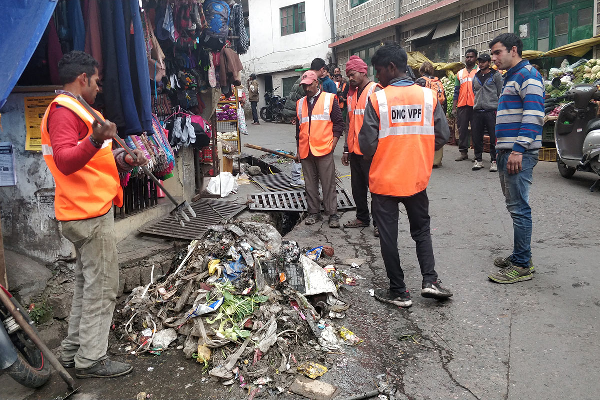 The cleaning squad of the Municipal Corporation Dharamshala scooping out debris from a drainage in McLeod Ganj, India, on 27 November 2018.