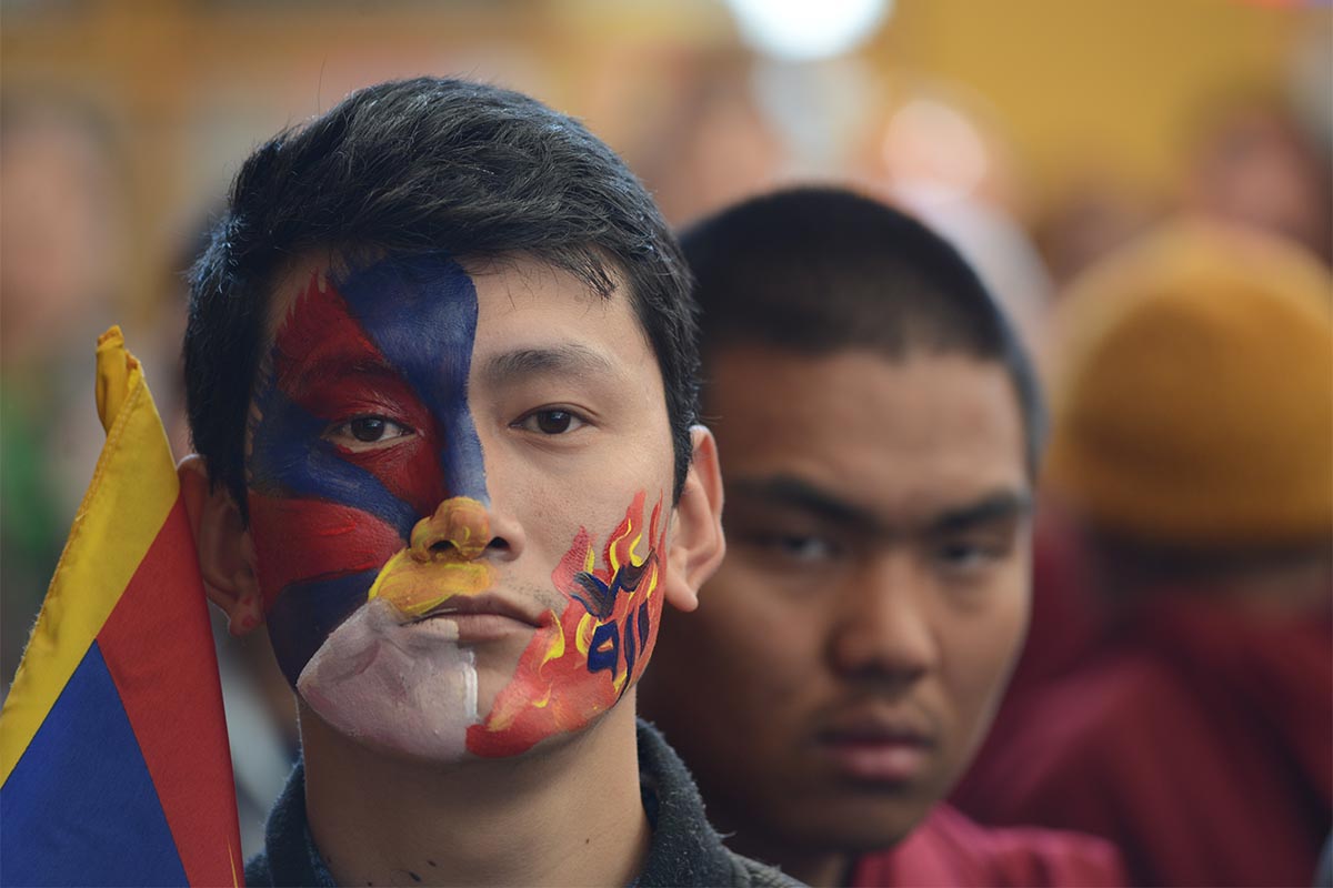 An exile Tibetan youth with face-painting of Tibet and Tibetan flag, during the 60th Tibetan Uprising Day commemorating the 1959 Tibetan uprising, in McLeod Ganj, India, on 10 March 2019.