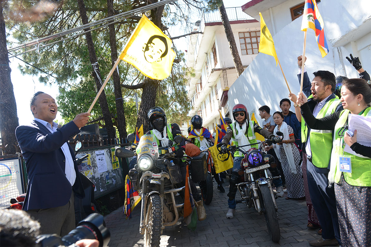 TYC President Tenzing Jigme (left) and National Director of Students for a Free Tibet-India, Rinzin Choedon (right), flag off a motorcycle rally marking the Panchen Lama turning 30 years of age, in McLeod Ganj, India, on 23 April 2019.