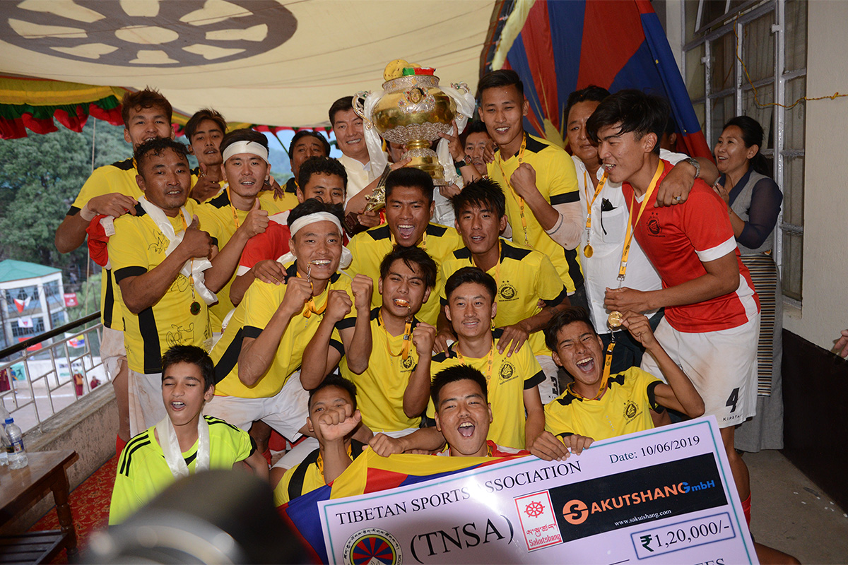 President of the Central Tibetan Administration, Lobsang Sangay, presents the GCM 2019 cup to Mundgod team after winning against Clement Town team in the penalty shootout, at TCV Grounds near McLeod Ganj, India, on 10 June 2019.