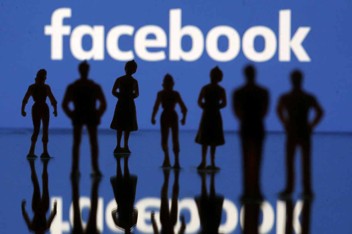 Small toy figures are seen in front of Facebook logo in this illustration picture, on 8 April 2019.