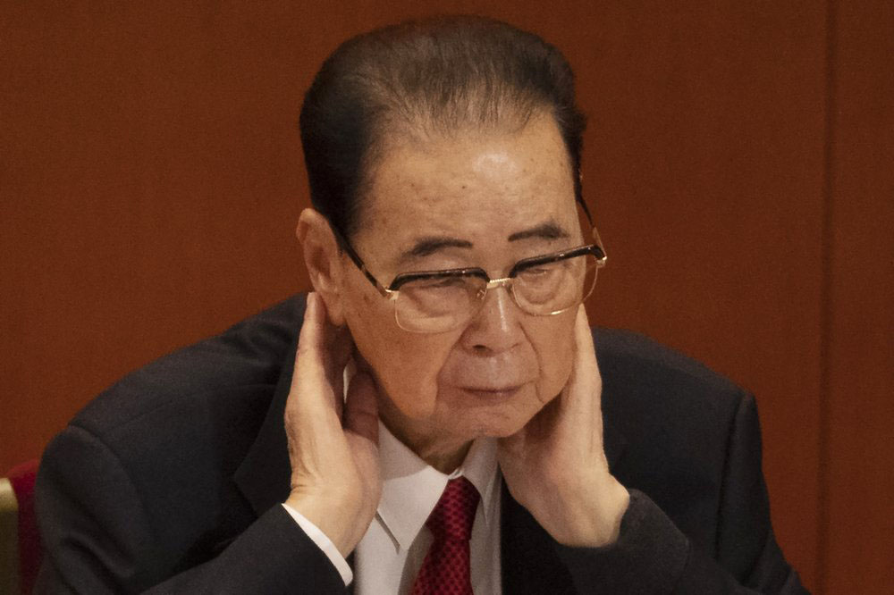 In this 24 October 2017 photo, former Chinese Premier Li Peng, places his hands around his neck during the closing session of China's 19th Party Congress at the Great Hall of the People in Beijing, China. Li Peng, a former hard-line Chinese premier best known for announcing martial law during the 1989 Tiananmen Square pro-democracy protests, has died on Monday 22 July 2019 of unspecified illness. He was 90.