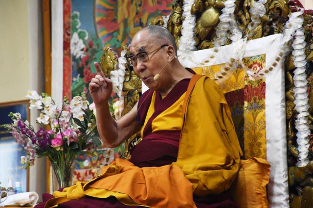 Tibetan spiritual leader the Dalai Lama gestures during long-life offering to him at Tsuglakhang Temple in McLeod Ganj, India, on 5 June 2019.