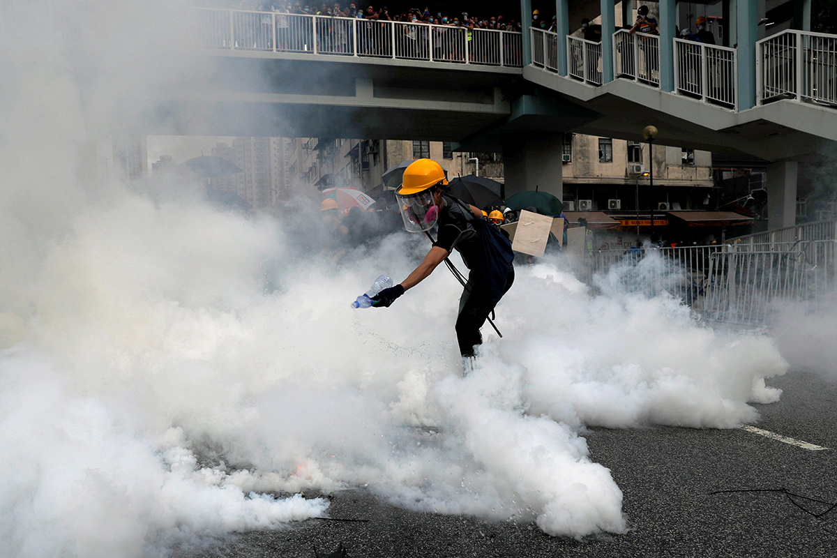 A demonstrator reacts to a tear gas during a protest against the Yuen Long attacks in Yuen Long, New Territories, Hong Kong, China, on 27 July 2019.