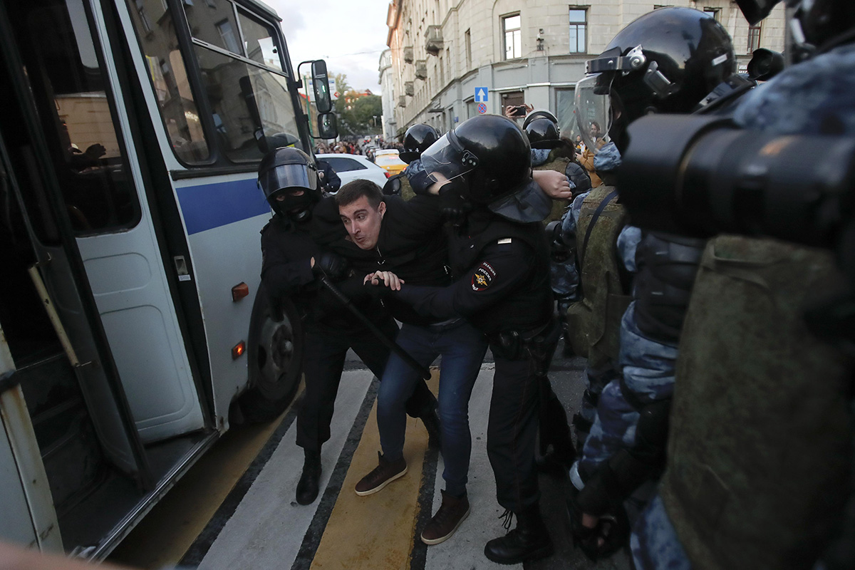 Law enforcement officers detain a man after a rally to demand authorities allow opposition candidates to run in the upcoming local election in Moscow, Russia, on 10 August 2019.