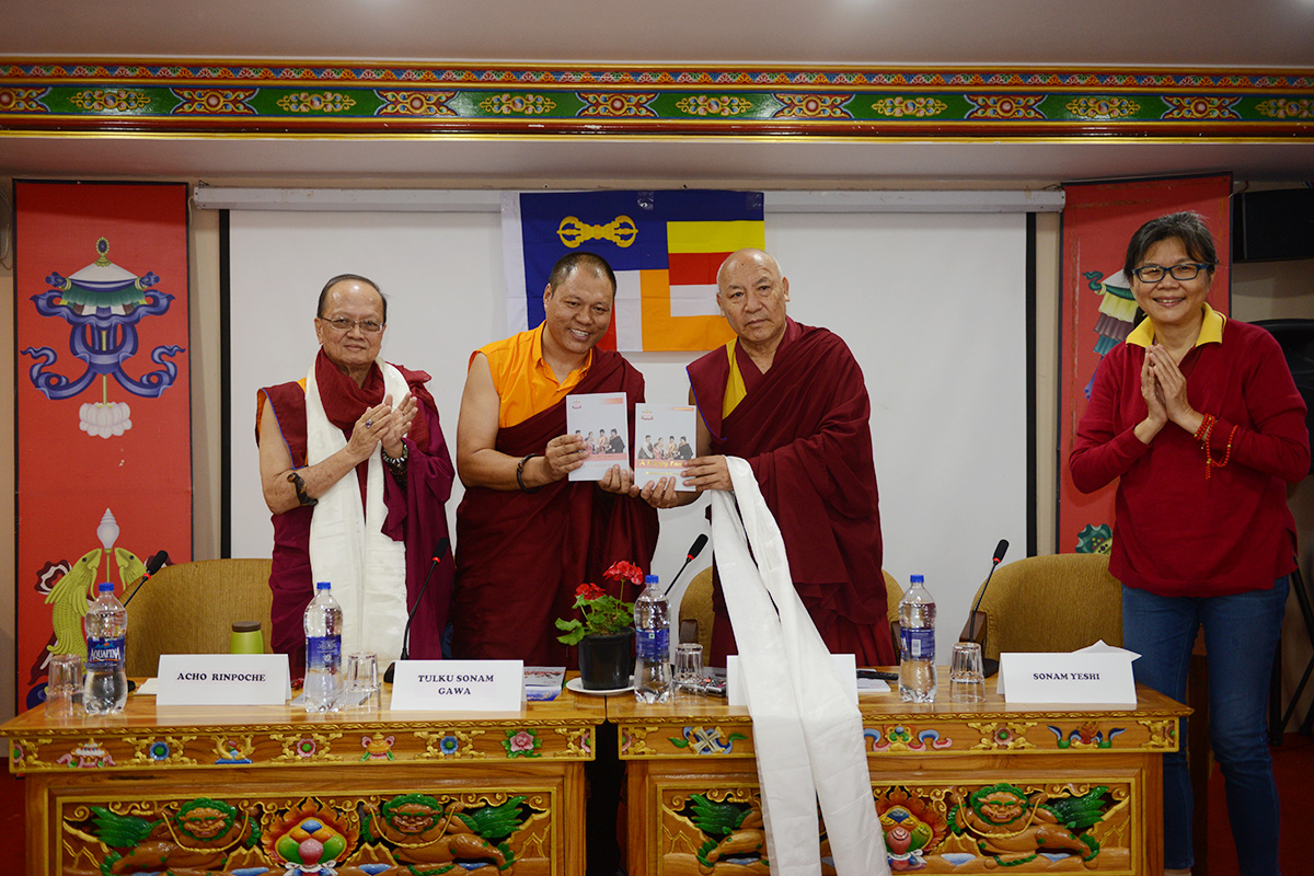 Geshe Lhakdor (second right) launches the book _A Happy Family_ by Tulku Sonam Gawa (aka Kunde Rinpoche), in McLeod Ganj, India, on 28 September 2019. On the left is Acho Rinpoche and Kunde Rinpoche's assistant Sonam Yeshi from Singapore.