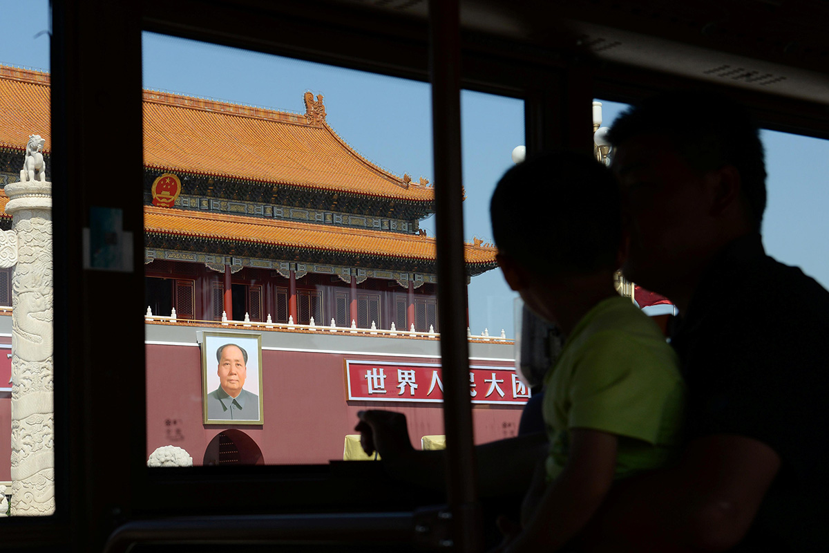 A man and a boy look at the Tiananmen Gate from a sightseeing bus on Changan Avenue ahead of the 70th founding anniversary of People's Republic of China in Beijing, China, on 16 September 2019.