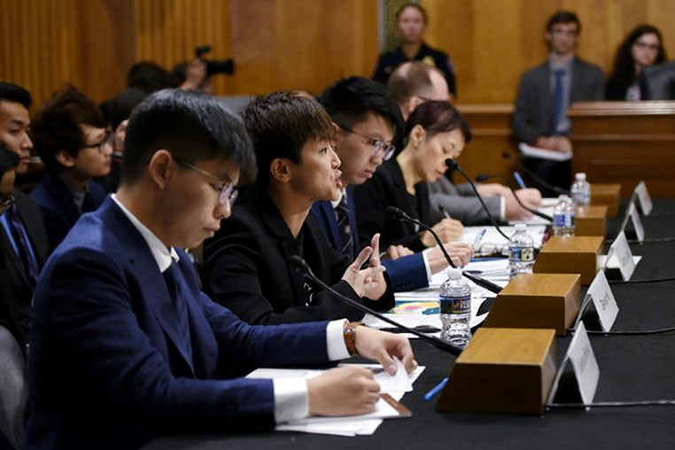 Hong Kong activist Joshua Wong (L) listens to testimony by singer-campaigner Denise Ho (C) before the US Congress in Washington DC on 17 September 2019.