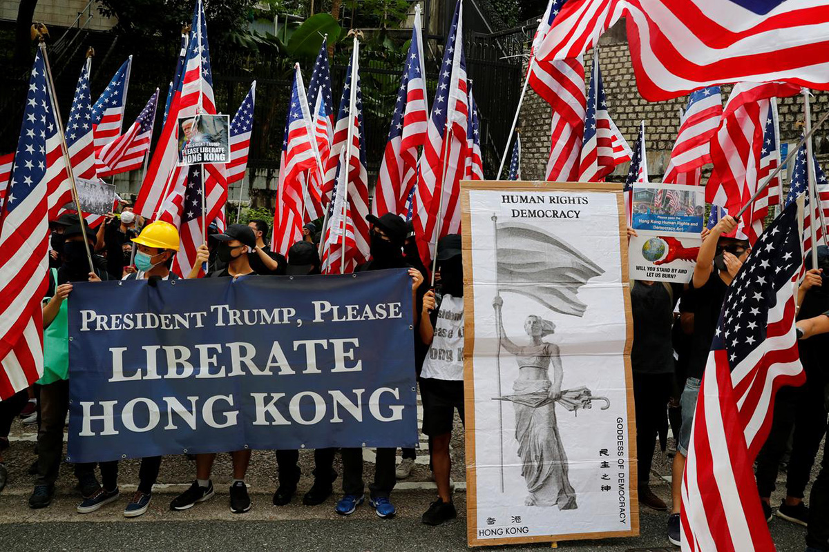 Protesters hold signs and US flags during a rally in Hong Kong, China, on 8 September 2019.
