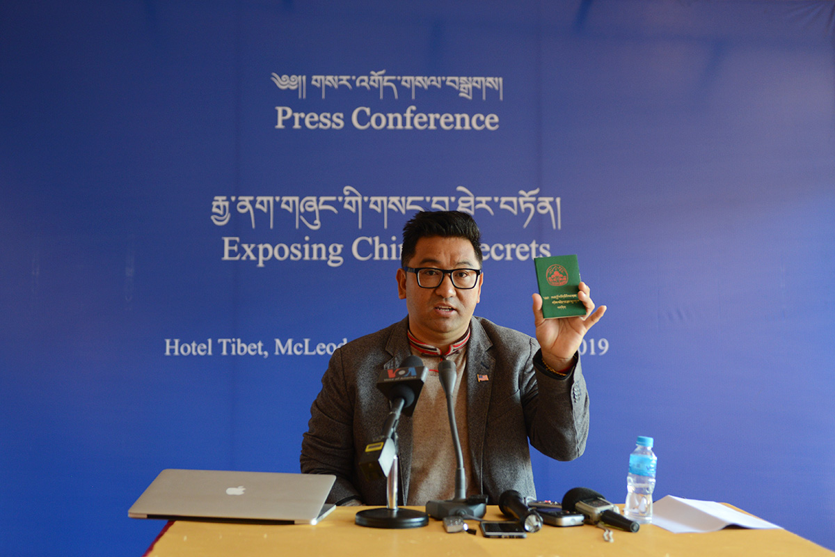 Dhamchoe Nyima shows his Green Book during a press conference in McLeod Ganj, India, on 24 October 2019. 