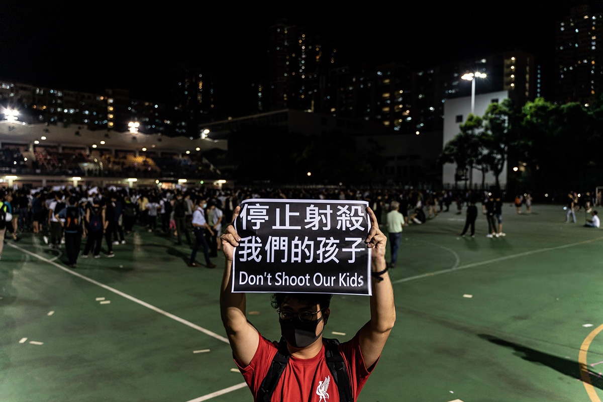 A pro-democracy protester hold a placard during a rally in Tuen Wan district in Hong Kong, China, on 2 October 2019. On 1 October, pro-democracy protesters marked the 70th anniversary of the founding of the People's Republic of China in Hong Kong with mass demonstrations across Hong Kong. The day was marred by the first injuries caused from police use of live ammunition with one student protester shot in the chest in the Tsuen Wan district.