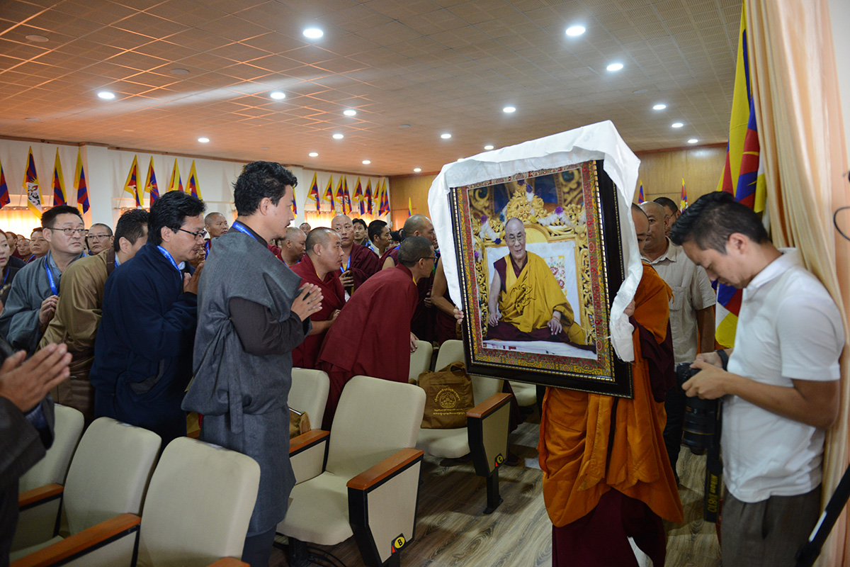 A monk from Nechung Monastery brings a portrait of Tibetan Spiritual leader the Dalai Lama, to be placed on a throne ahead of the opening of the Third Special General Meeting of Tibetans-in-exile, in Dharamshala, India, on 3 October 2019. 
