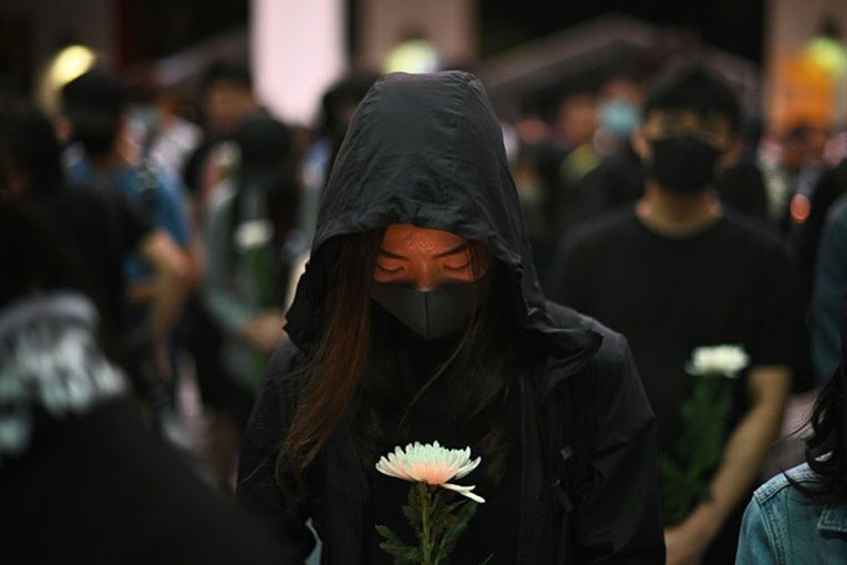 There were tearful vigils to mourn the death of a student who died during clashes with police in Hong Kong.