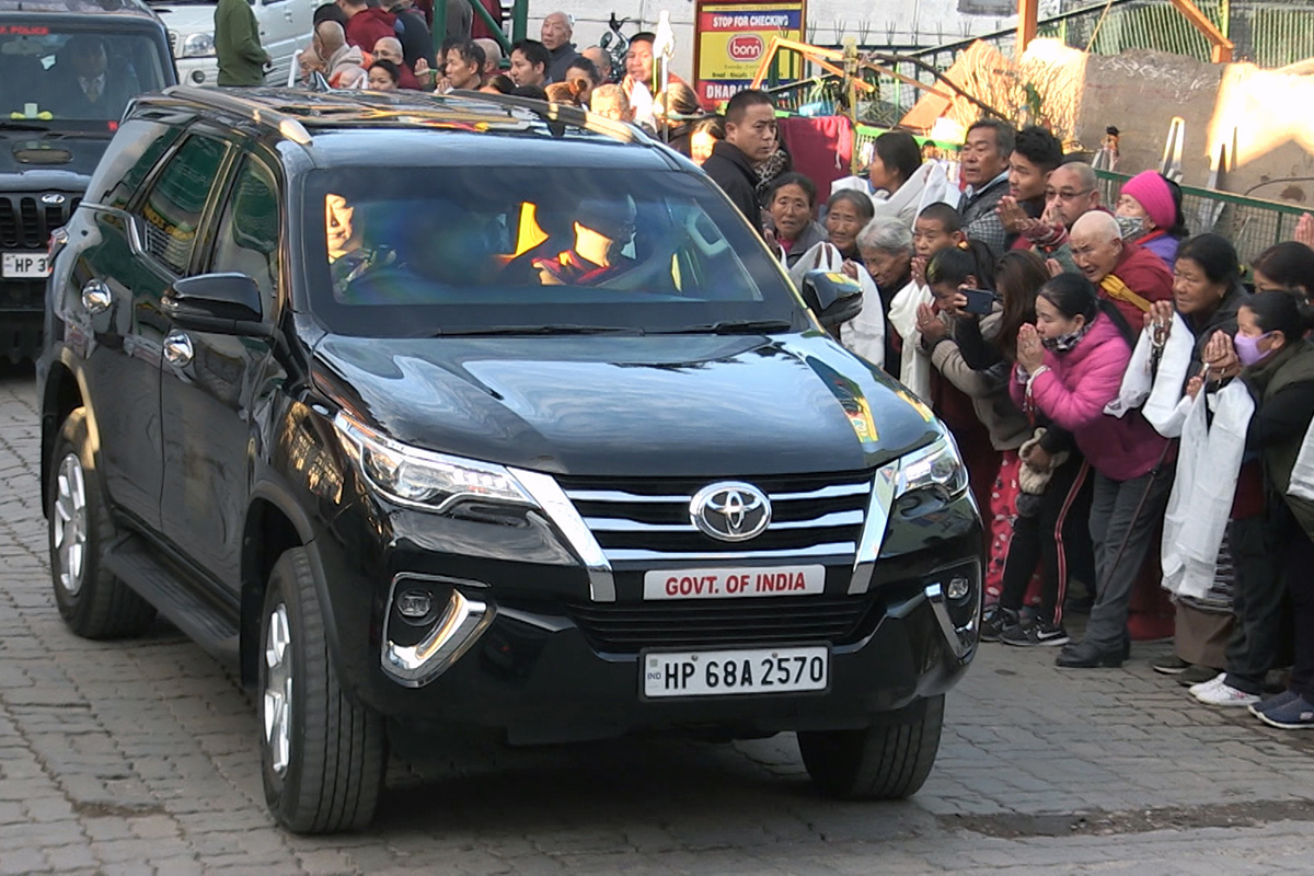 Tibetan spiritual leader the Dalai Lama waves from his car to his devotees and well-wishers as he leaves for South India, in McLeod Ganj, India, on 9 December 2019. 